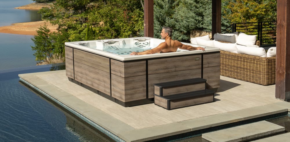 A person sits in a hot tub.