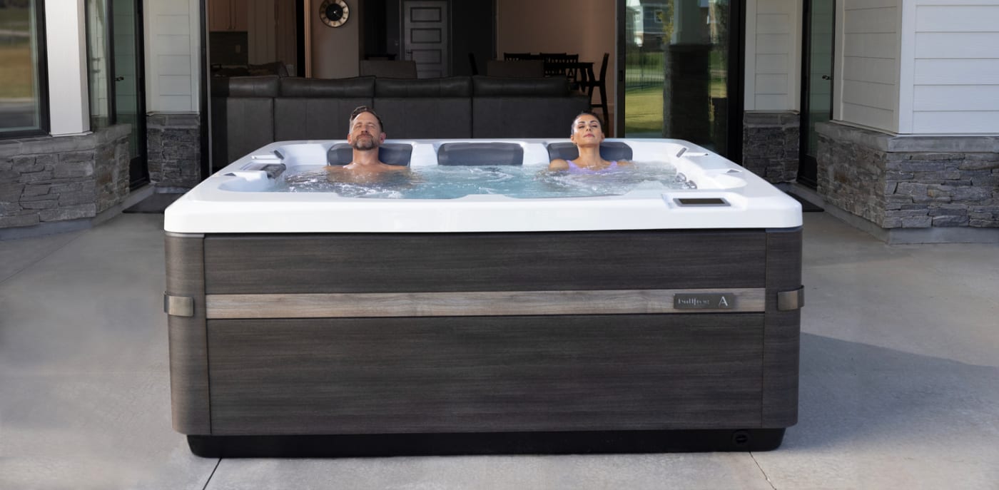 Four people sit in a hot tub
